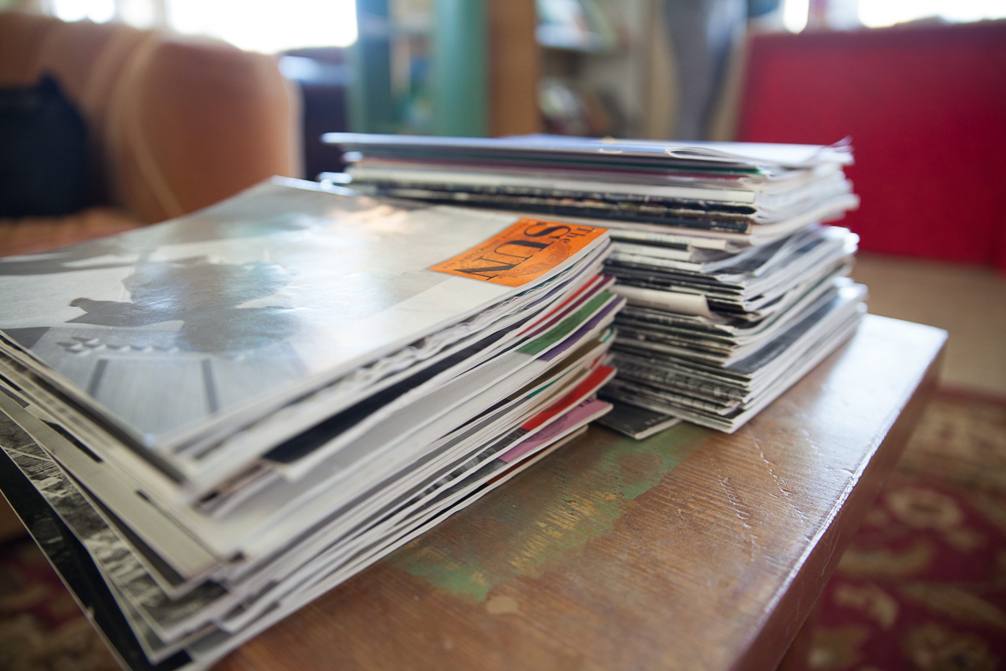 A stack of magazines atop a wooden table at SOMOS in Taos, New Mexico.